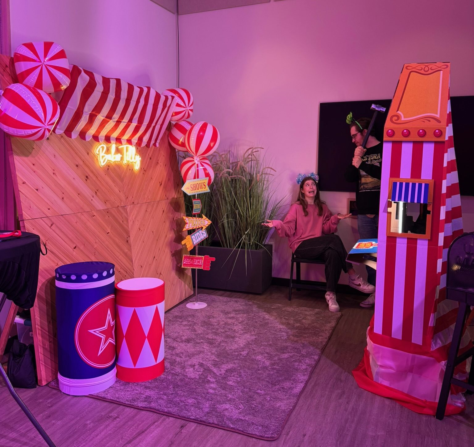 Carnival-themed Woody Wall with a custom neon sign at a corporate event