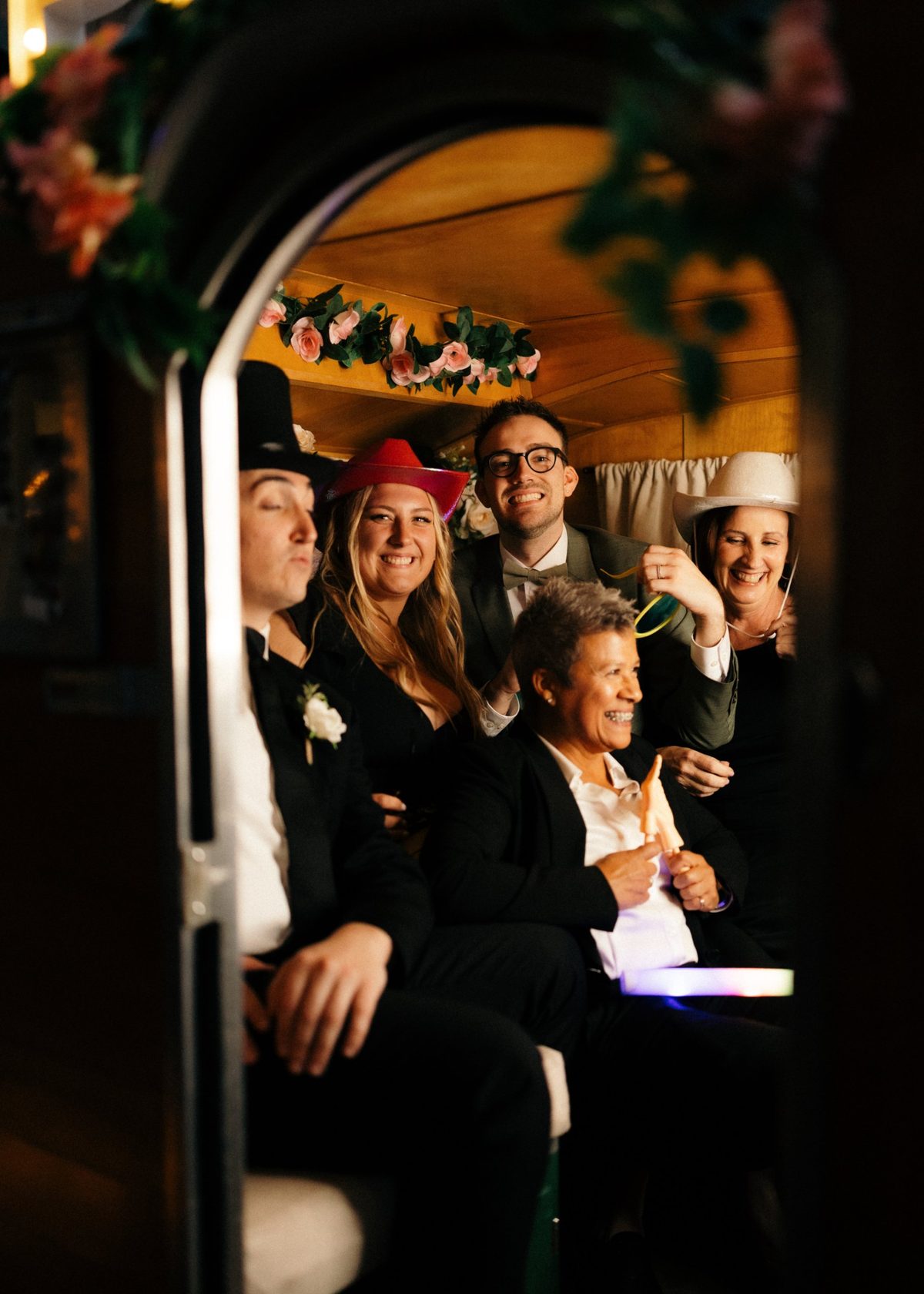 Guests laughing together in costume hats inside the trailer