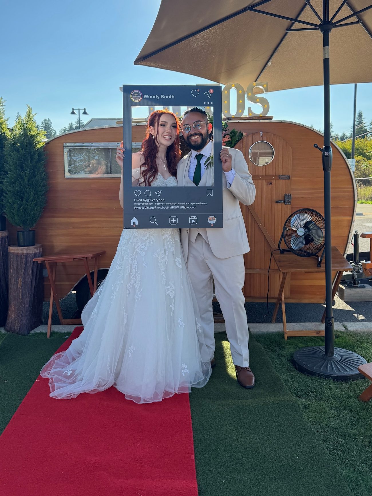 Bride and groom holding a Woody Booth Instagram-style frame